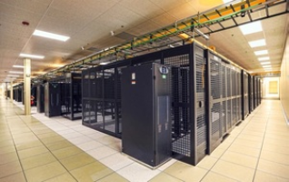 A data center illuminated by overhead lights.