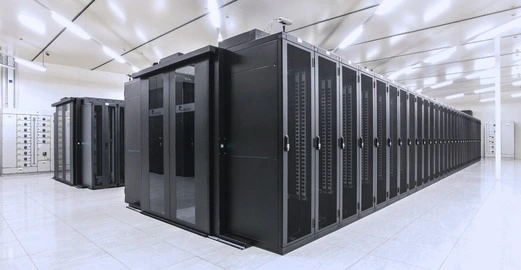A modern data center featuring rows of black server racks with glass doors, set in a clean, brightly lit environment.